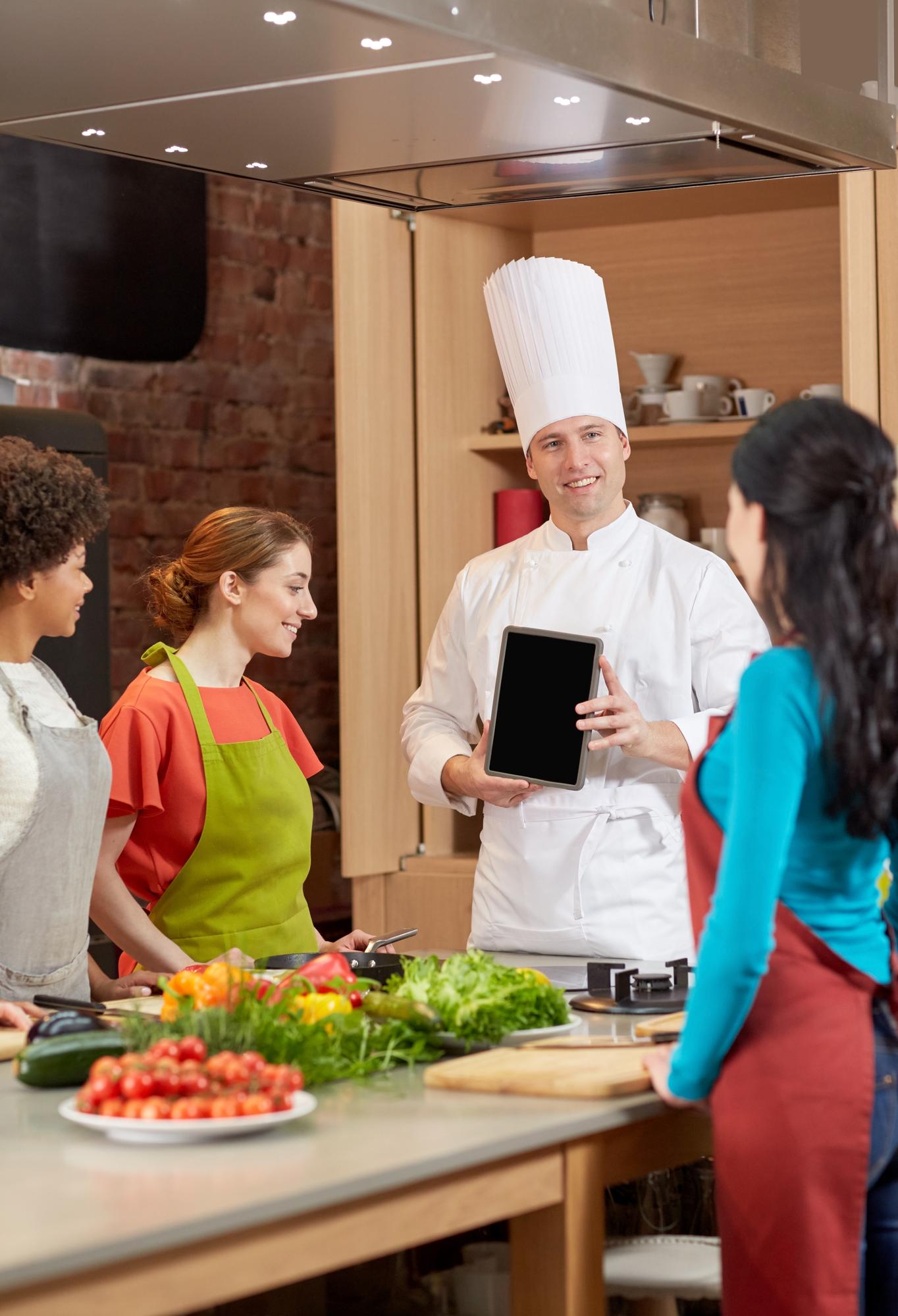 Chef speaking to students in kitchen